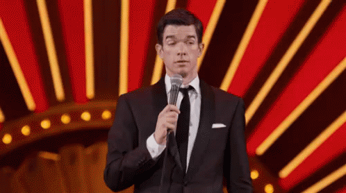 Man in Tuxedo and Tie Holding Microphone