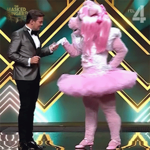 Man In Tuxedo And Woman In Pink Ballerina Costume GIF