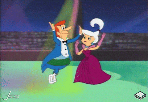 Man In Tuxedo And Woman In Purple Dress High Fiving GIF