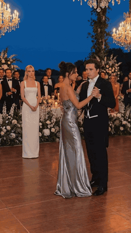 Man in Tuxedo and Woman in Silver Dress Dancing
