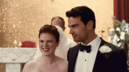Man In Tuxedo And Woman In Wedding Dress Smiling GIF