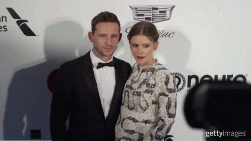 Man In Tuxedo And Woman In White Dress GIF