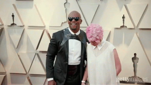 Man in Tuxedo and Woman with Pink Hair Posing