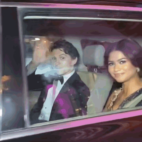 Man In Tuxedo And Woman Woman In Dress Sitting In Car GIF