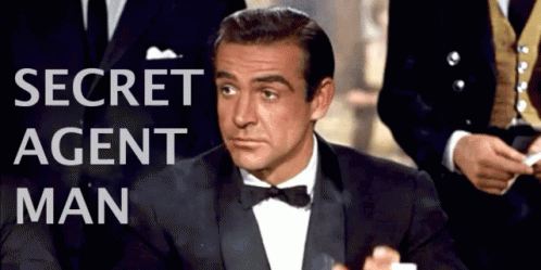 Man in Tuxedo at Secret Agent Man Sign