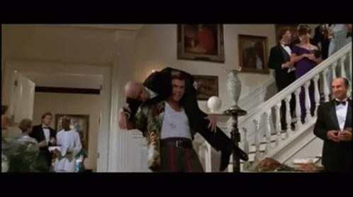 Man In Tuxedo Carrying Another Man On Shoulders GIF