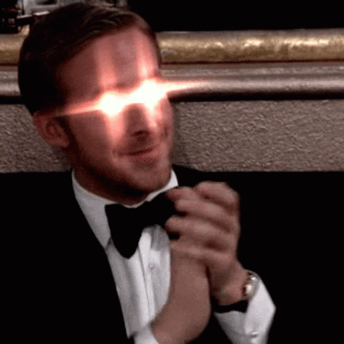 Man in Tuxedo Clapping Hands With Glowing Eyes