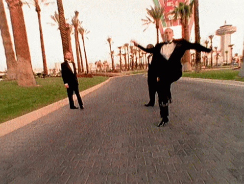 Man In Tuxedo Dancing On Brick Road GIF