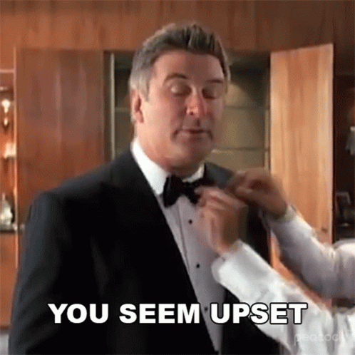 Man in Tuxedo Getting Bow Tie Adjusted by Man in White Shirt