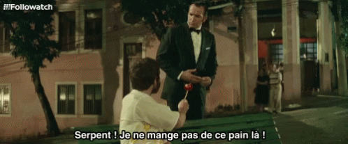 Man In Tuxedo Giving Lollipop GIF