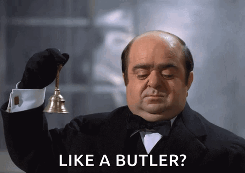 Man in Tuxedo Holding Bell Saying Like a Butler