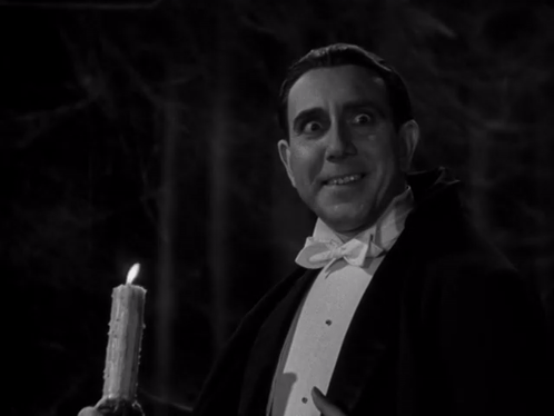 Man in Tuxedo Holding Candle