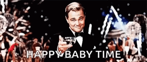 Man in Tuxedo Holding Champagne in Front of Crowd