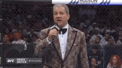 Man In Tuxedo Holding Microphone GIF