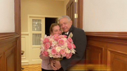 Man in Tuxedo Holding Pink Bouquet