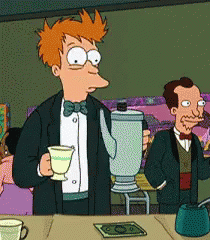 Man in Tuxedo Holding Tea and Blender
