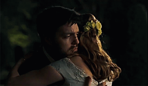 Man in Tuxedo Hugging Woman in White Dress
