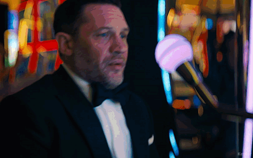 Man In Tuxedo In Front Of Slot Machine With Word Ke GIF