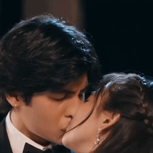 Man In Tuxedo Kissing Woman In Dress GIF