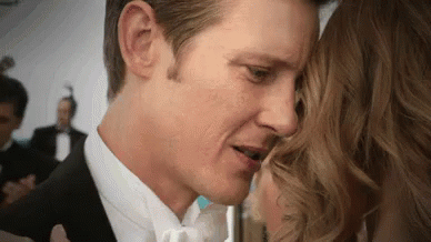 Man in Tuxedo Kissing Woman on Forehead