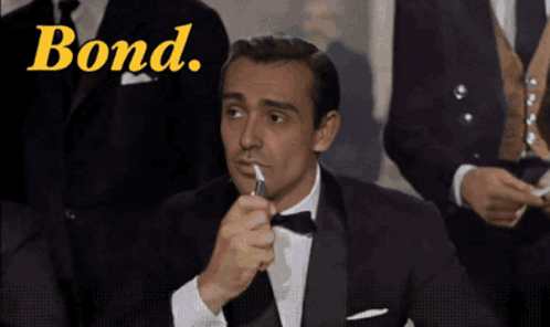 Man In Tuxedo Lighting Cigarette Bond GIF