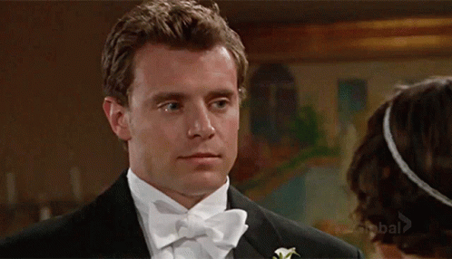 Man In Tuxedo Looking At Woman GIF