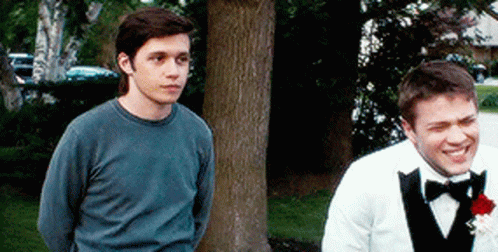 Man In Tuxedo Next To Man In Blue Shirt GIF