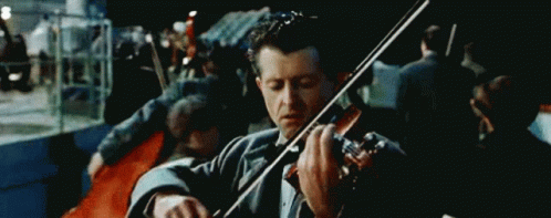 Man In Tuxedo Playing Violin In Front Of Crowd GIF