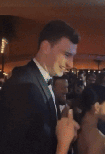 Man in Tuxedo Pointing at Woman
