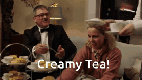 Man In Tuxedo Pouring Creamy Tea Into Woman GIF