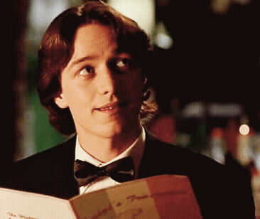 Man in Tuxedo Reading Mediterranean Menu