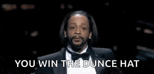 Man in Tuxedo Saying You Win the Dunce Hat