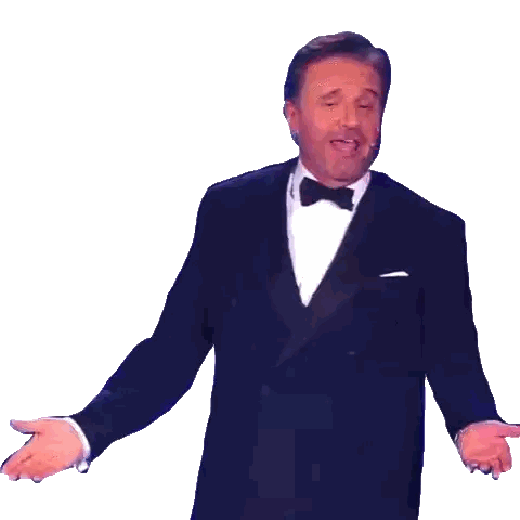 Man in Tuxedo Singing Into Microphone