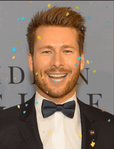 Man In Tuxedo Smiling Beside Letter N GIF