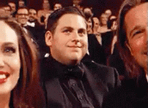 Man in Tuxedo Smiling in Crowd