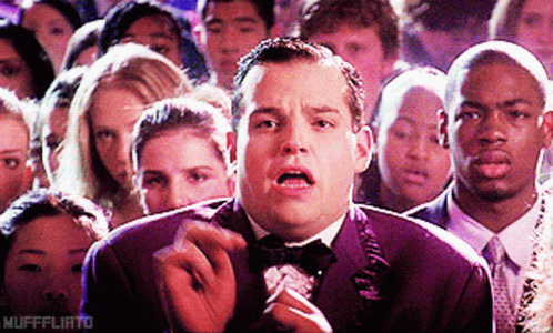 Man In Tuxedo Smoking Cigarette In Crowd Mufffliato GIF