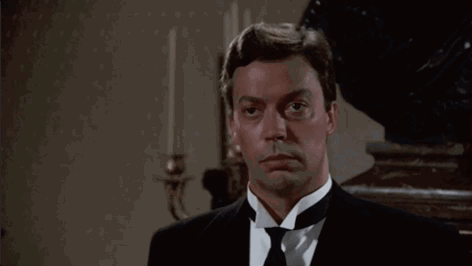 Man in Tuxedo Standing in Room With Candles
