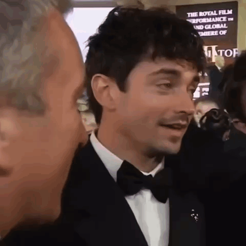 Man in Tuxedo Talking to Another