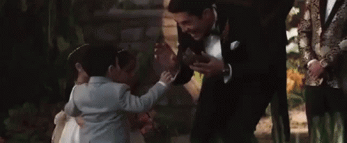 Man in Tuxedo Talking to Little Girl