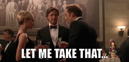 Man in Tuxedo Talking to Woman in Black Dress Saying Let Me Take That