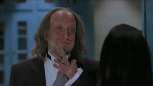 Man in Tuxedo Talking to Woman