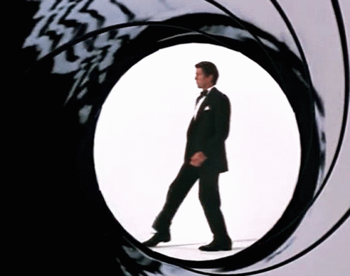 Man In Tuxedo Walking Through Circular Hole GIF