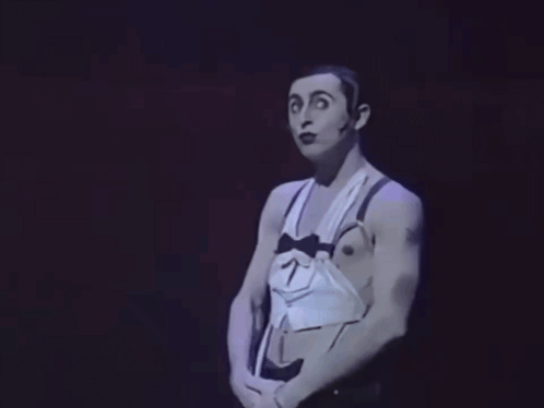 Man in Tuxedo With Bow Tie and Suspenders Making Funny Face