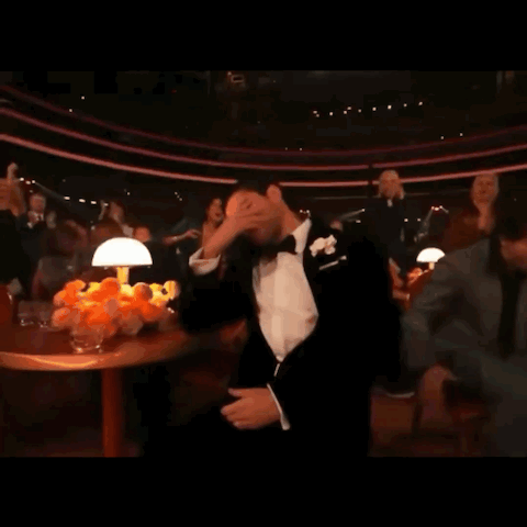Man in Tuxedo With Bow Tie Covering Face