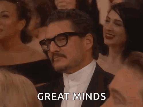 Man In Tuxedo With Glasses And Mustache Sitting In Crowd GIF