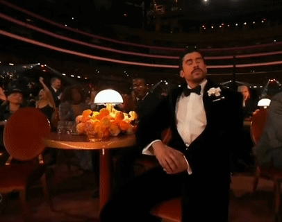 Man in Tuxedo With Hand on Face