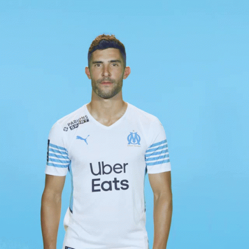 Man In Uber Eats Shirt On Blue Background GIF