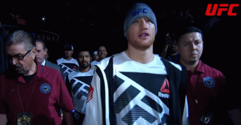 Man In UFC Beanie Walks Through Crowd GIF