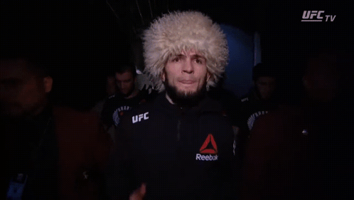 Man In UFC Glove Covers Face In Dark GIF