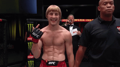 Man in UFC Gloves Next to Referee